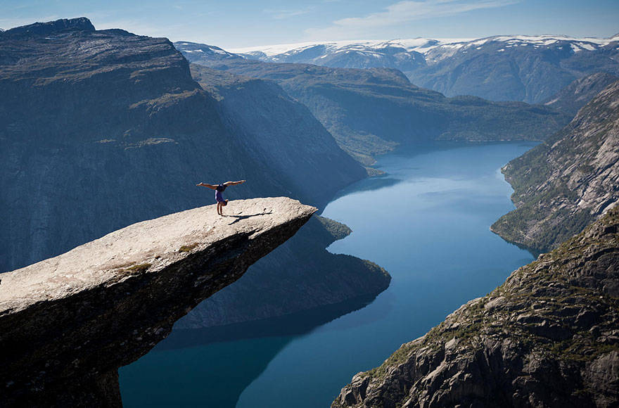 Doing some yoga on Norway's Trolltunga.