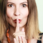 Woman asking for silence with finger on lips