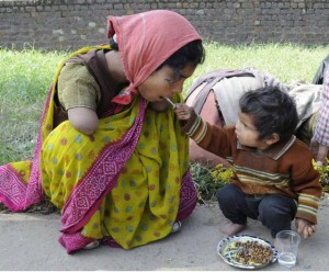 2 Year Old Offering Food To Her Handicapped Mom