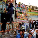 Actress Angelina Jolie climbs aboard a bus during her visit to the Kacha Gari refugee camp in …