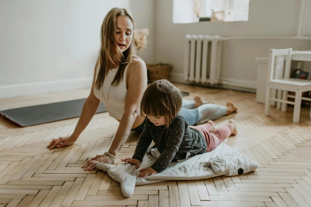 mom daughter doing yoga together