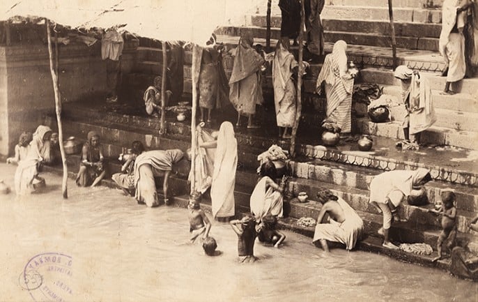 Bathing in the holy river Ganges, Benares, an albumen photo, c.1870-80