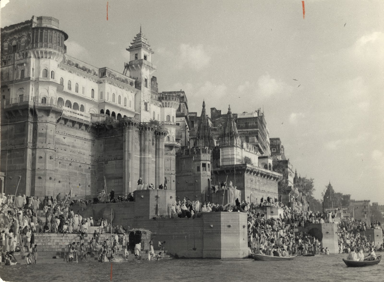 Hindu Pilgrims mass on the ghats on Ganges River at Banaras (Varanasi) under walls of palace during a festival - c1940-50's