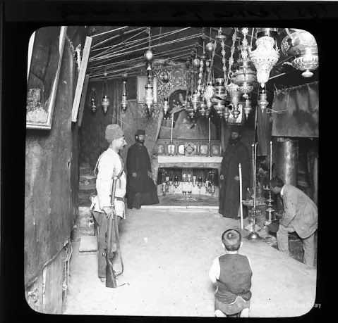 The Grotto beneath the Church of the Nativity in Bethlehem. The man on the right is believed to be the photographer, David Brown_1897.