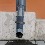black drain pipe on concrete wall