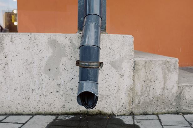 black pipe on concrete wall