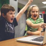 kids playing video game and excited