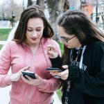 ladies comparing smartphones