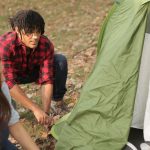 man women hiking tent preparation