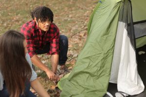 man women hiking tent preparation