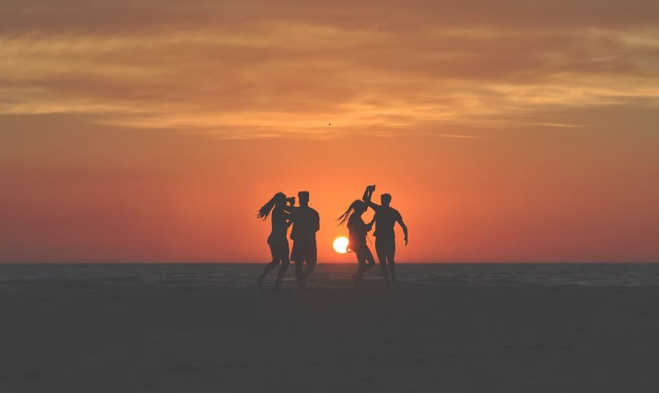 Couples playing on beach at sunset | reckon talk Couples playing on beach at sunset