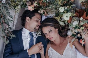 romantic man and woman between flowers