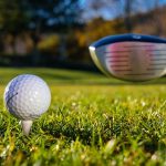 golf stick on verge on hitting ball