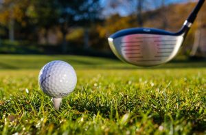 golf stick on verge on hitting ball