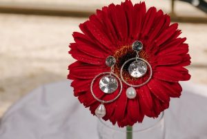 silver earrings on flower