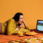 women watching tv and eating