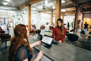 two young women talking and working