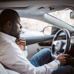 man thinking about rent while driving
