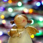smiling toy girl with a golden heart in hand