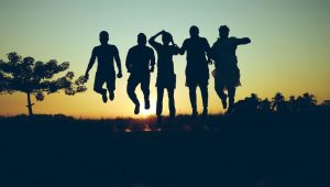 happy people jumping in the evening