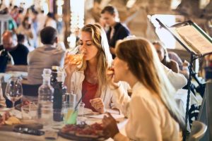 girls dinning at a crowded restaurant