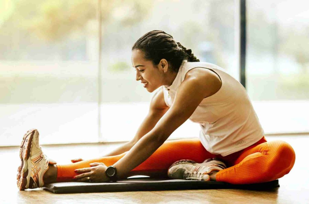 woman stretching on ground