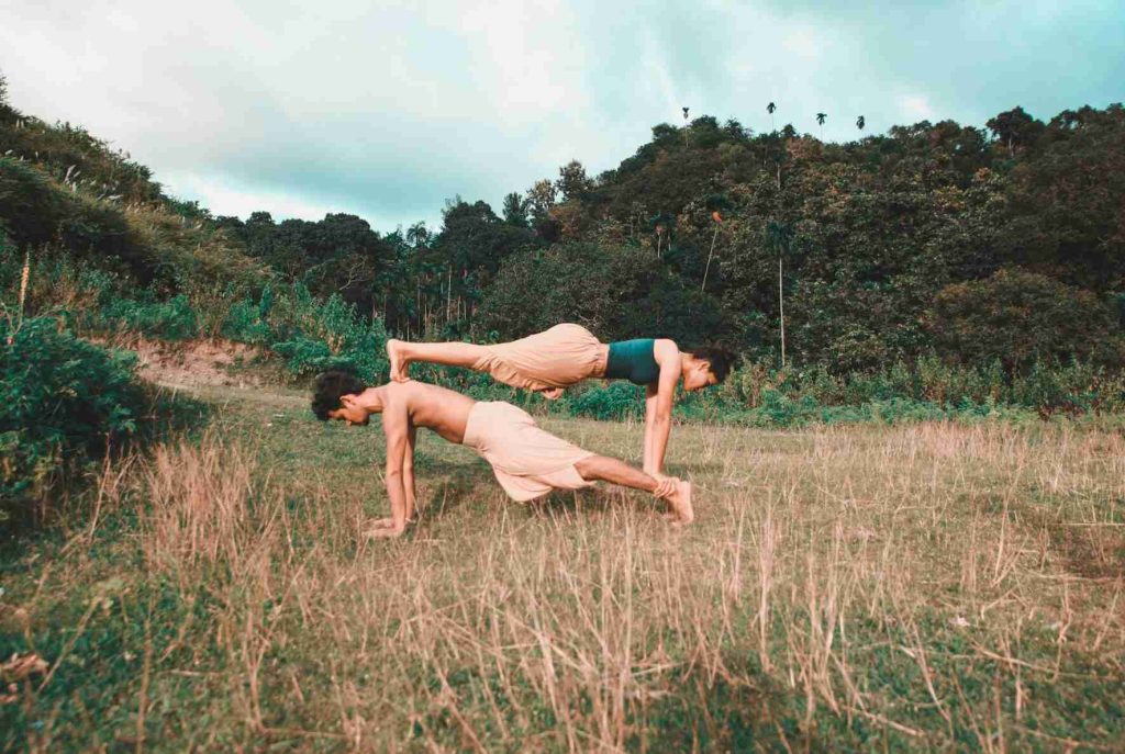 man and women doing yoga together