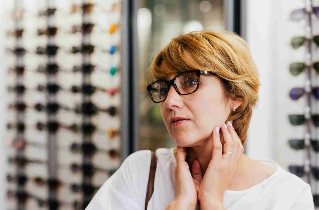 Women choosing eyeglasses to impress others