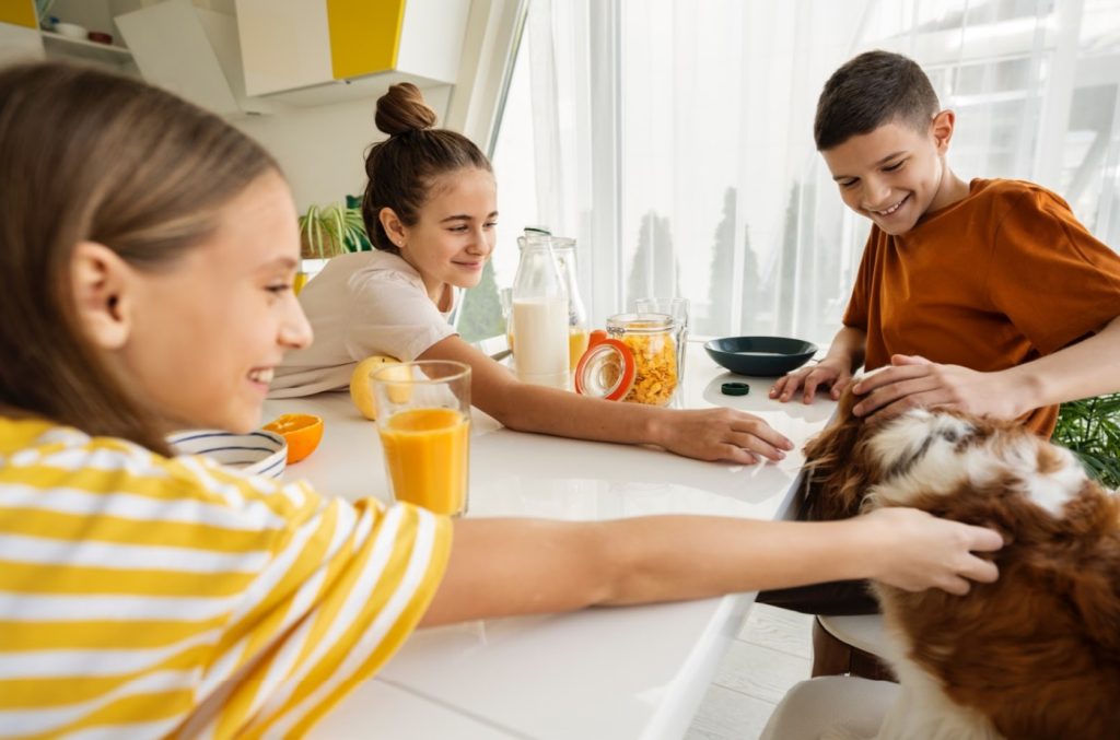 kids caressing hair of a dog